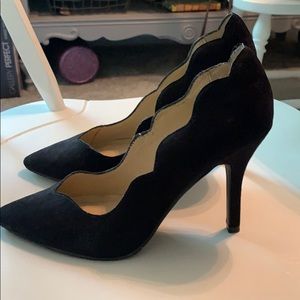 Scalloped black suede pumps